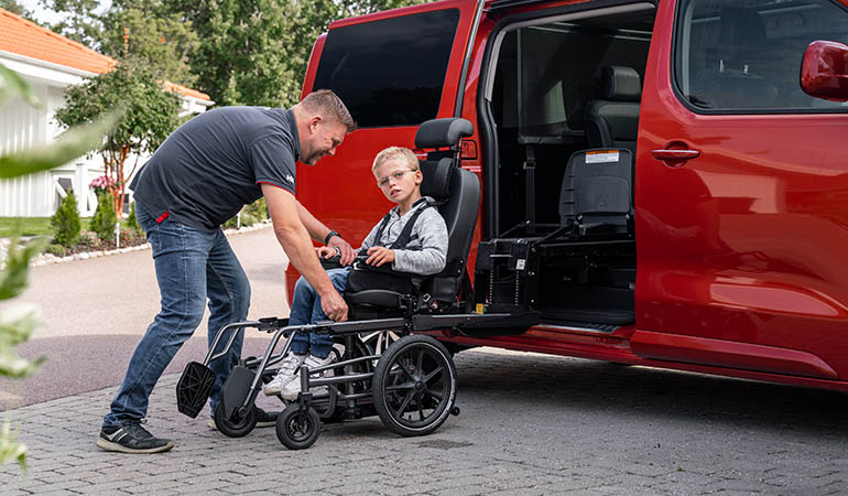 transfert de la personne en fauteuil roulant dans la voiture - Carony